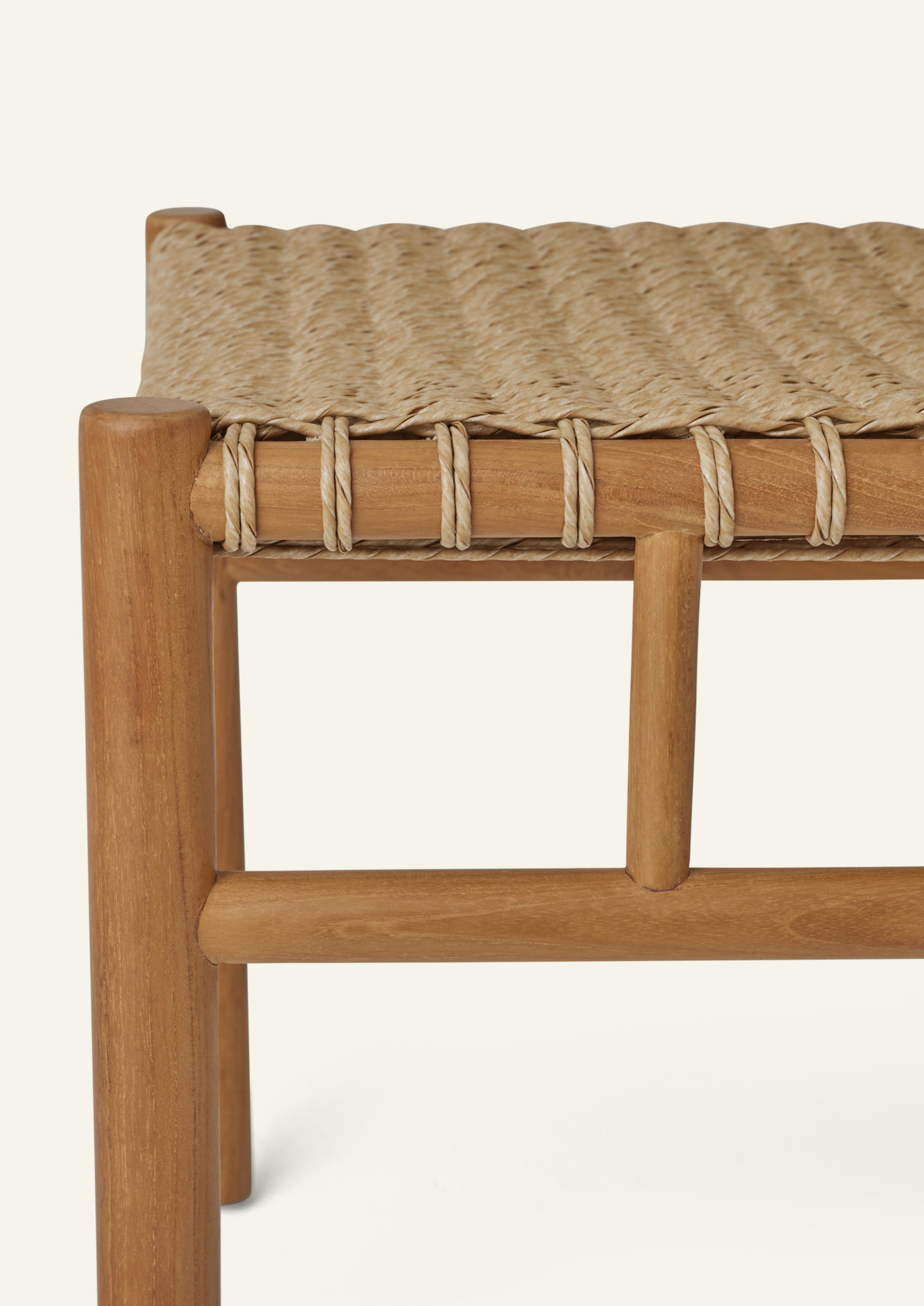 Close-up of the woven seat construction, highlighting the intricate synthetic paper cord weave wrapped around the solid teak frame. The UV-treated material offers the warmth of natural fiber with enhanced durability.