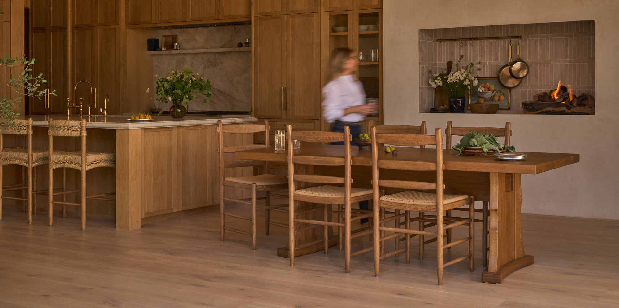 Wooden dining area with chairs and a table in a kitchen setting.