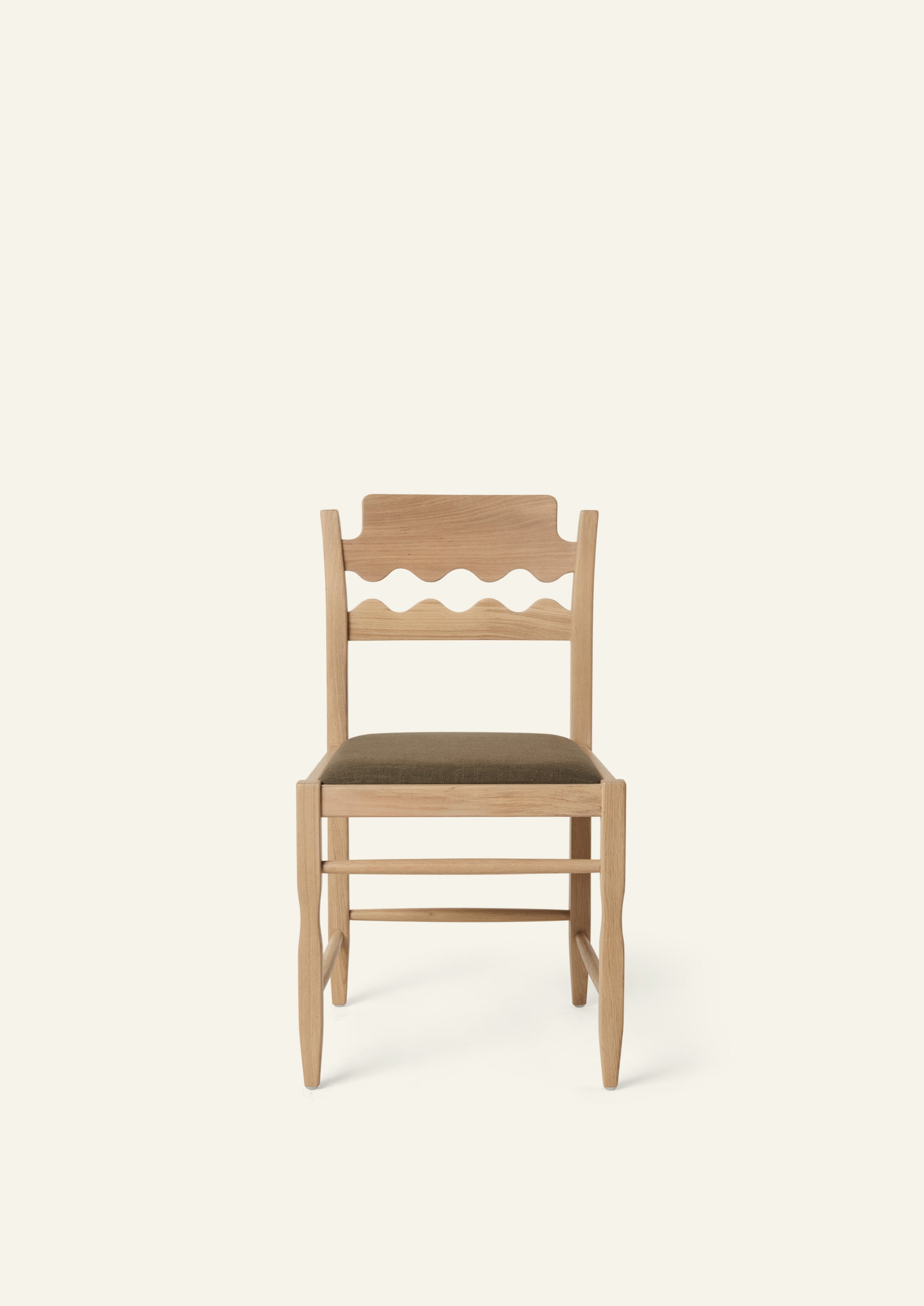 Front view of the Freda Razor Dining Chair in natural oak with an upholstered performance olive linen seat. The hand-carved scalloped backrest adds a playful yet timeless detail.