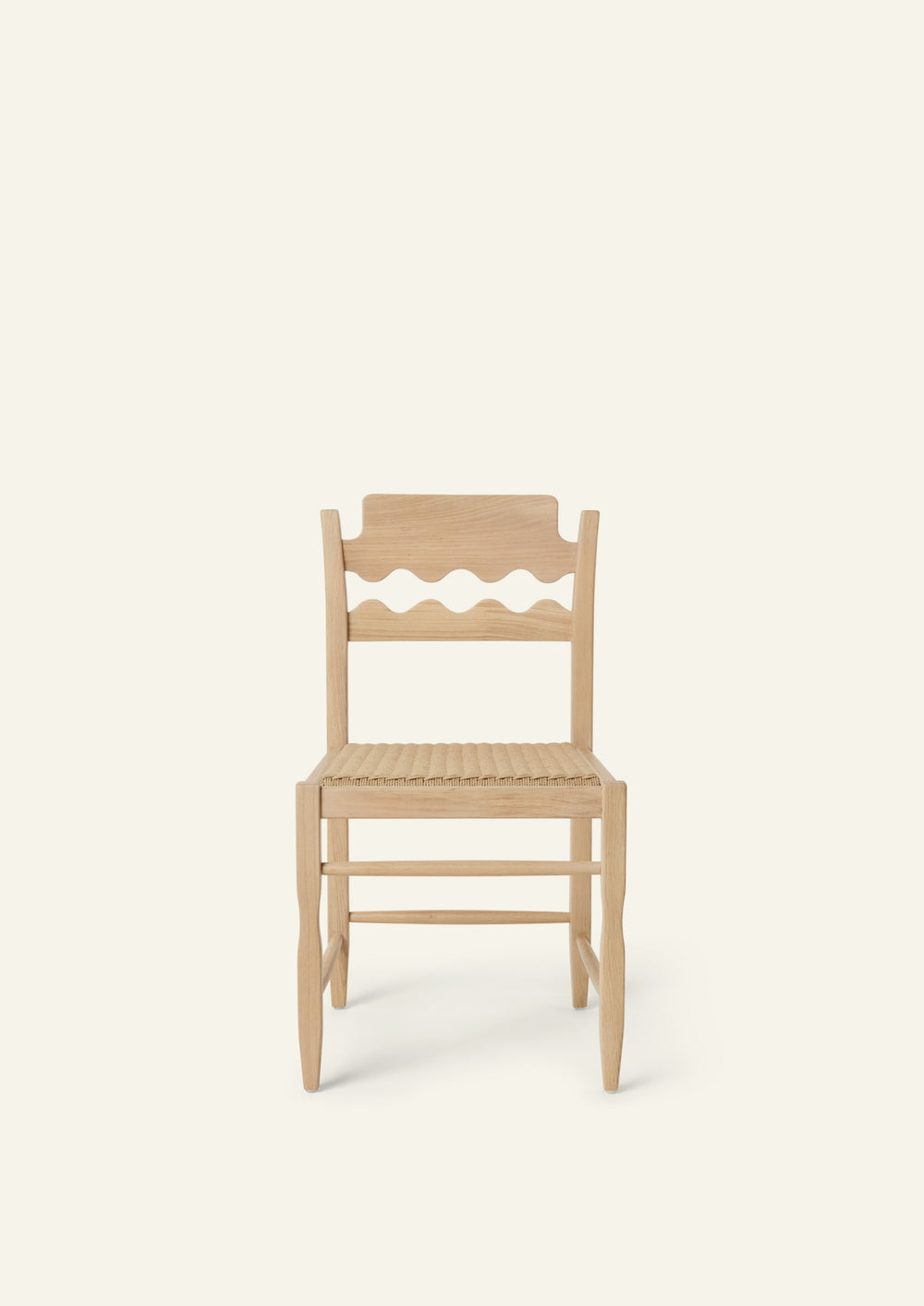 Front view of the Freda Razor Dining Chair in natural oak with a woven paper cord seat. The hand-carved scalloped backrest adds a playful yet timeless detail.