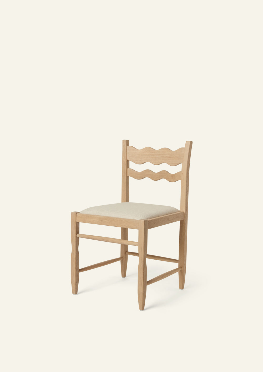 Freda Wave Dining Chair in natural oak with an upholstered performance sand linen seat, shown from an angled front view on a neutral background. The hand-carved scalloped backrest adds a playful yet timeless detail.