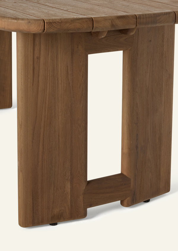 Close-up of the table’s sculptural pedestal base, showcasing solid reclaimed teak construction, substantial proportions, and clean architectural lines designed for durability and stability.