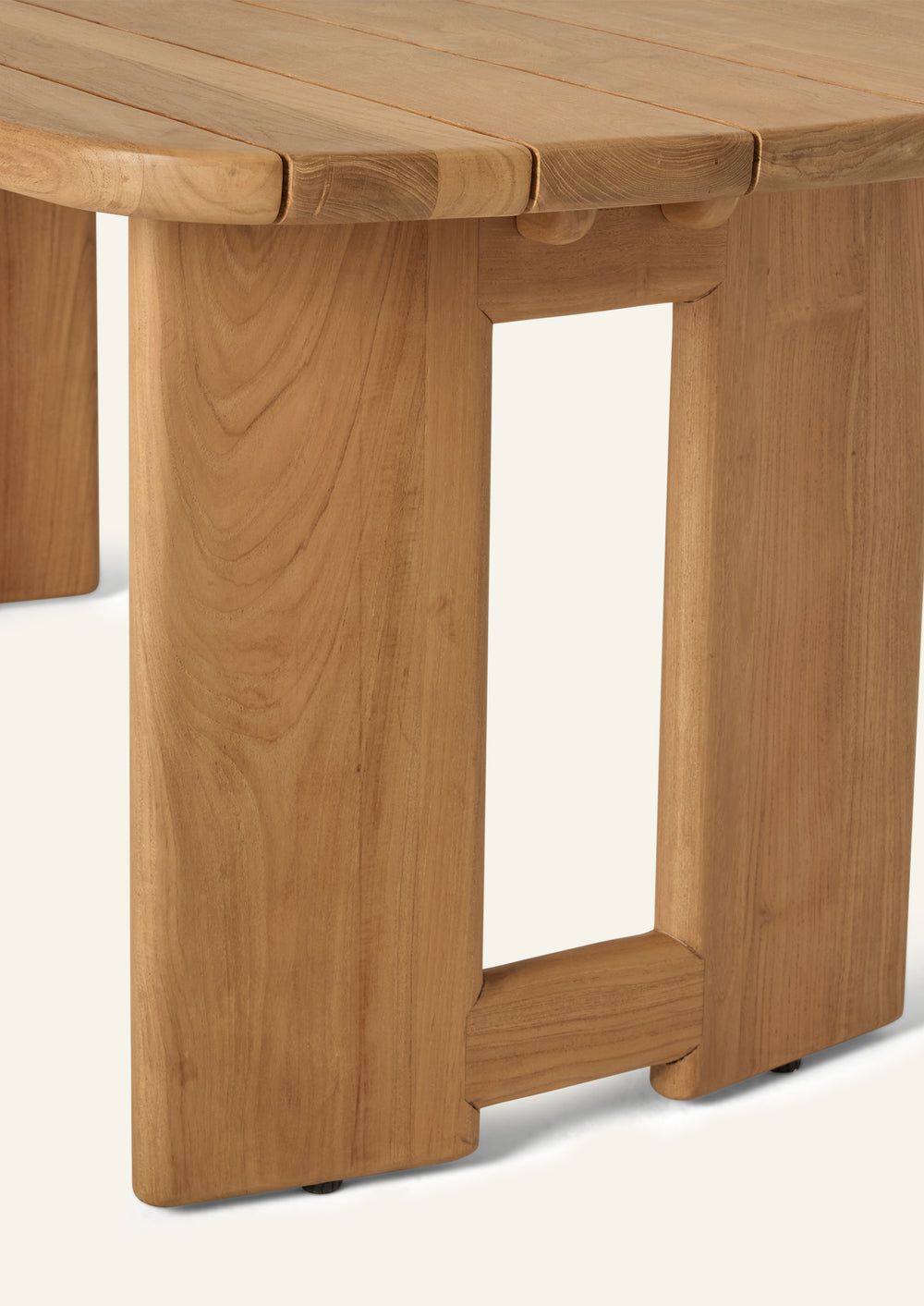 Close-up of the table’s pedestal base, showcasing solid teak construction, clean geometric forms, and exposed joinery details. The substantial supports provide stability while contributing to the table’s architectural silhouette.