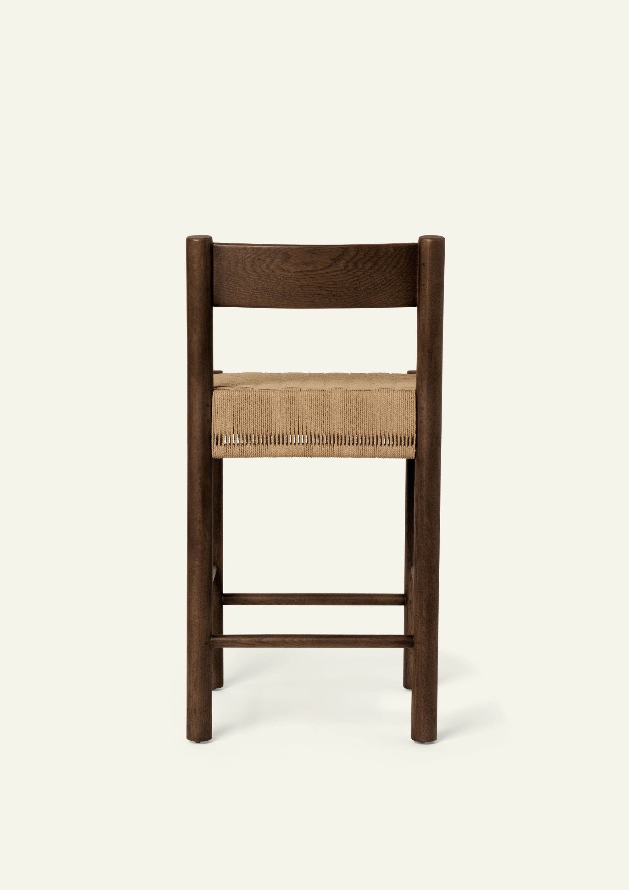 Rear view highlighting the stool's simple back construction and beautifully finished brown oak frame.