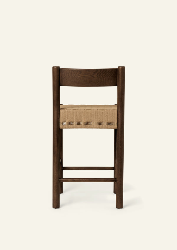 Rear view highlighting the stool's simple back construction and beautifully finished brown oak frame.