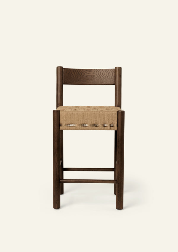 Front view of the Isa Counter Stool featuring a clean-lined silhouette, woven seat, and supportive backrest.