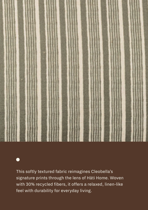 Close-up of green stripe fabric featuring soft green and ivory stripes with a subtle woven texture. Made with recycled fibers, the textile offers a relaxed, linen-like appearance and everyday durability.