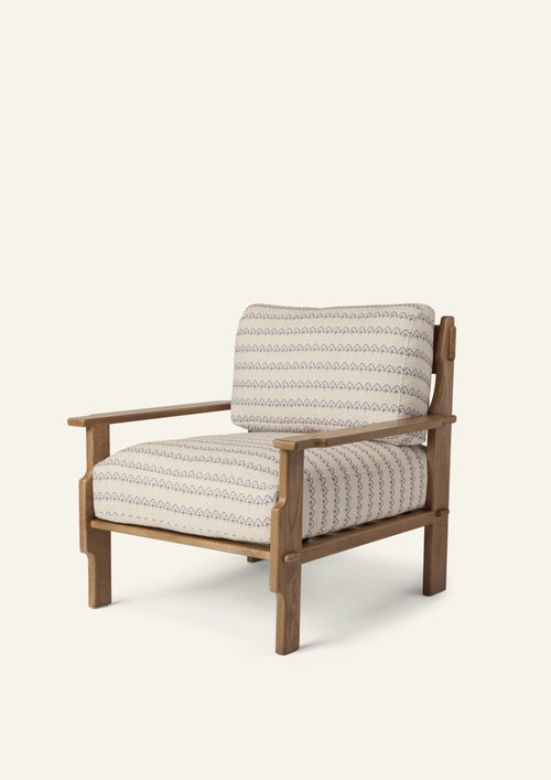 Lounge chair upholstered in Neutral Arches fabric with a solid honey oak frame. The soft geometric pattern and plush cushions create a comfortable, relaxed silhouette with timeless appeal.