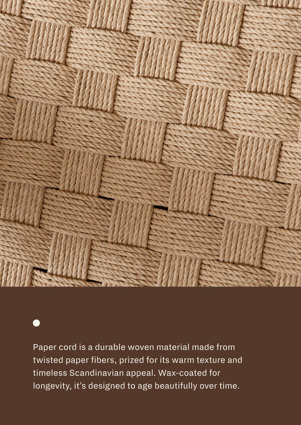 Close-up detail of the woven paper cord used on the chair’s seat and backrest, showcasing the basketweave pattern and textured surface of the durable woven fibers. Wax-coated for longevity, it's designed to age beautifully over time.