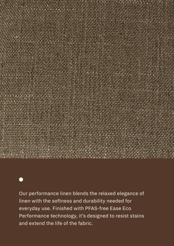 Textured dark green fabric with a brown bar at the bottom containing product description text. "Our performance linen blends the relaxed elegance of linen with the softness and durability needed for everyday use. Finished with PFS-free Eae Eco Performance technology, it's designed to resist stains and extend the life of the fabric. 