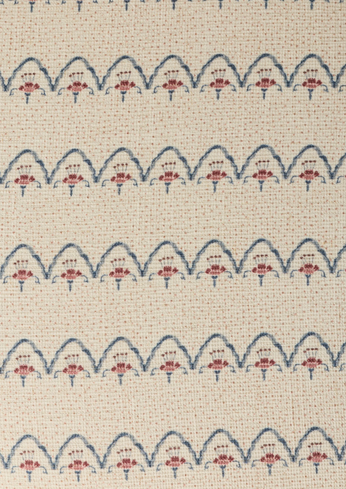 Close-up shot of the Cleobella Neutral arches fabric. Small dots around a floral arch pattern on an ivory base.