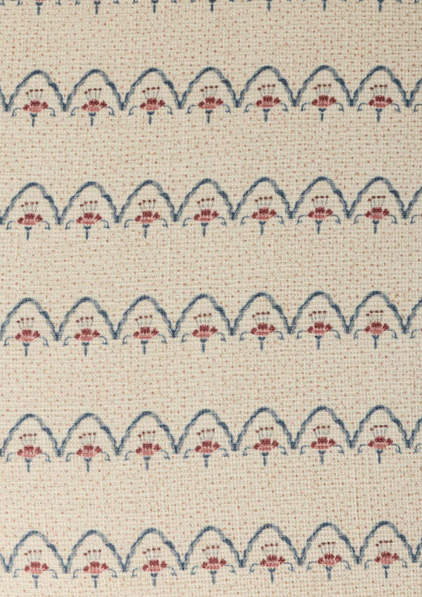 Close-up shot of the Cleobella Neutral arches fabric. Small dots around a floral arch pattern on an ivory base.