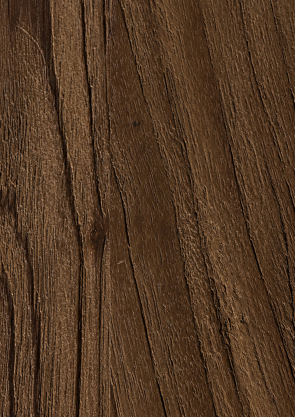 Close-up of a dark brown teak surface with visible grain