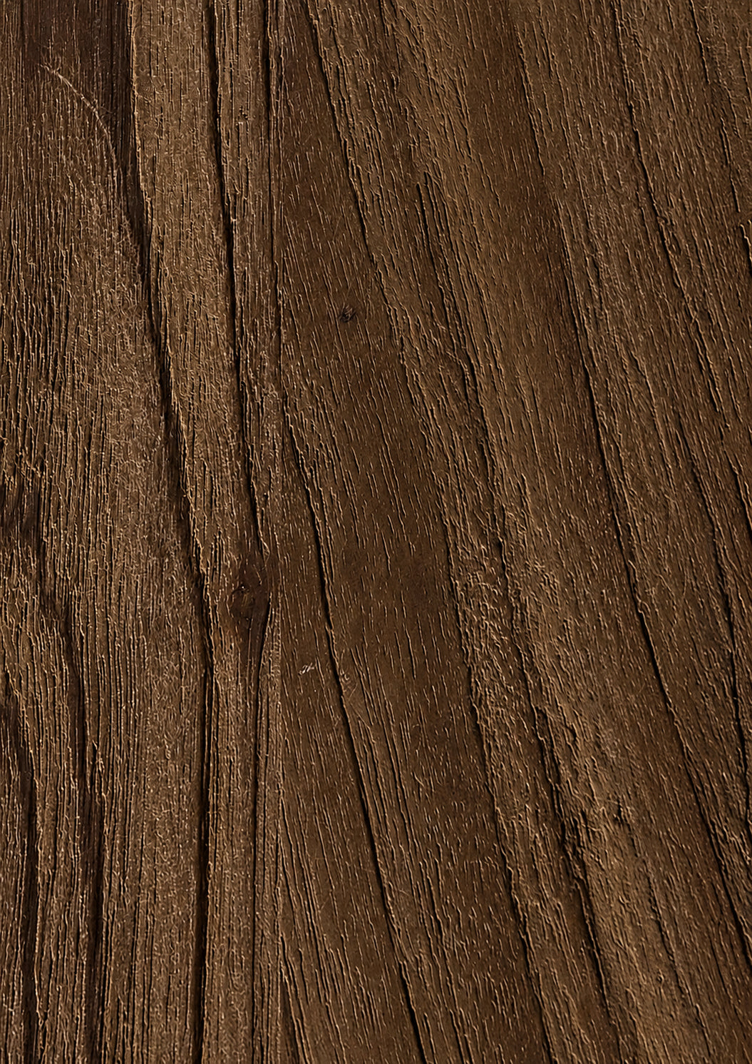 Close-up of a dark brown teak surface with visible grain