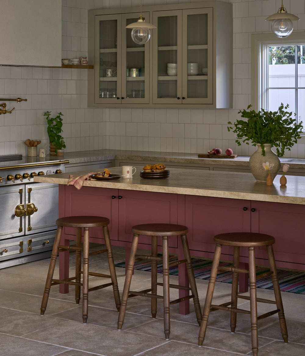 Modern kitchen with a mauve island and Lea brown oak counter stools. 