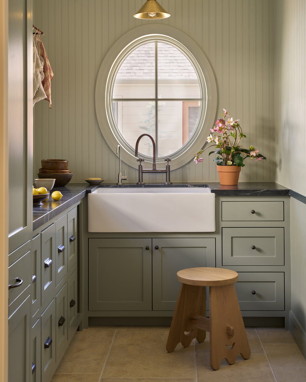 The senja side table in a green butlers pantry with bright light shining in.
