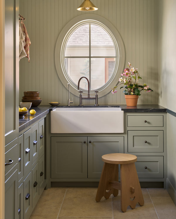 The senja side table in a green butlers pantry with bright light shining in.