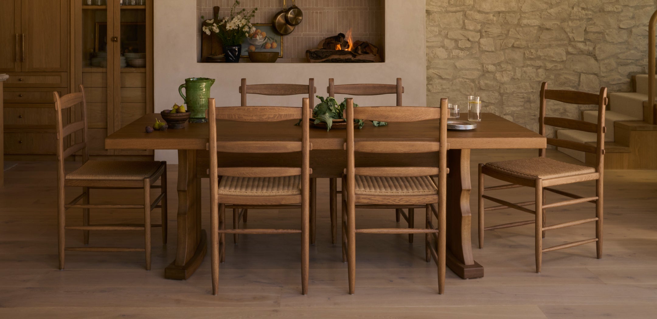 Etta honey oak dining table with tiga honey oak dining chairs in a warm, rustic room.