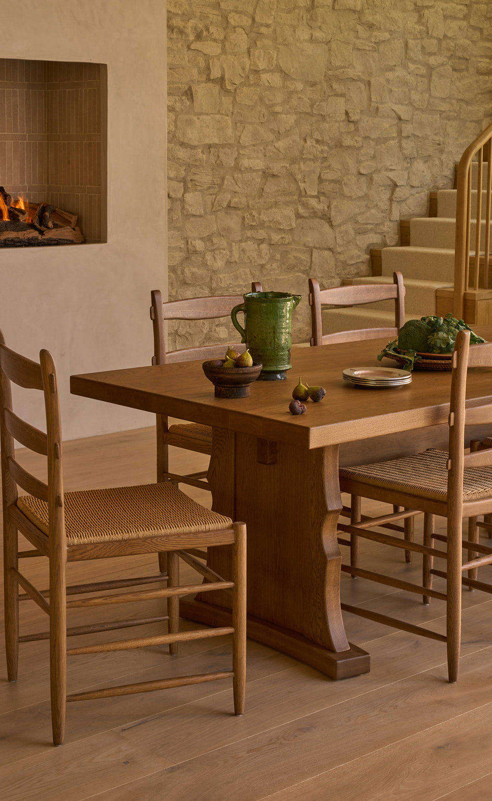 Etta honey oak dining table with tiga honey oak dining chairs in a warm, rustic room.