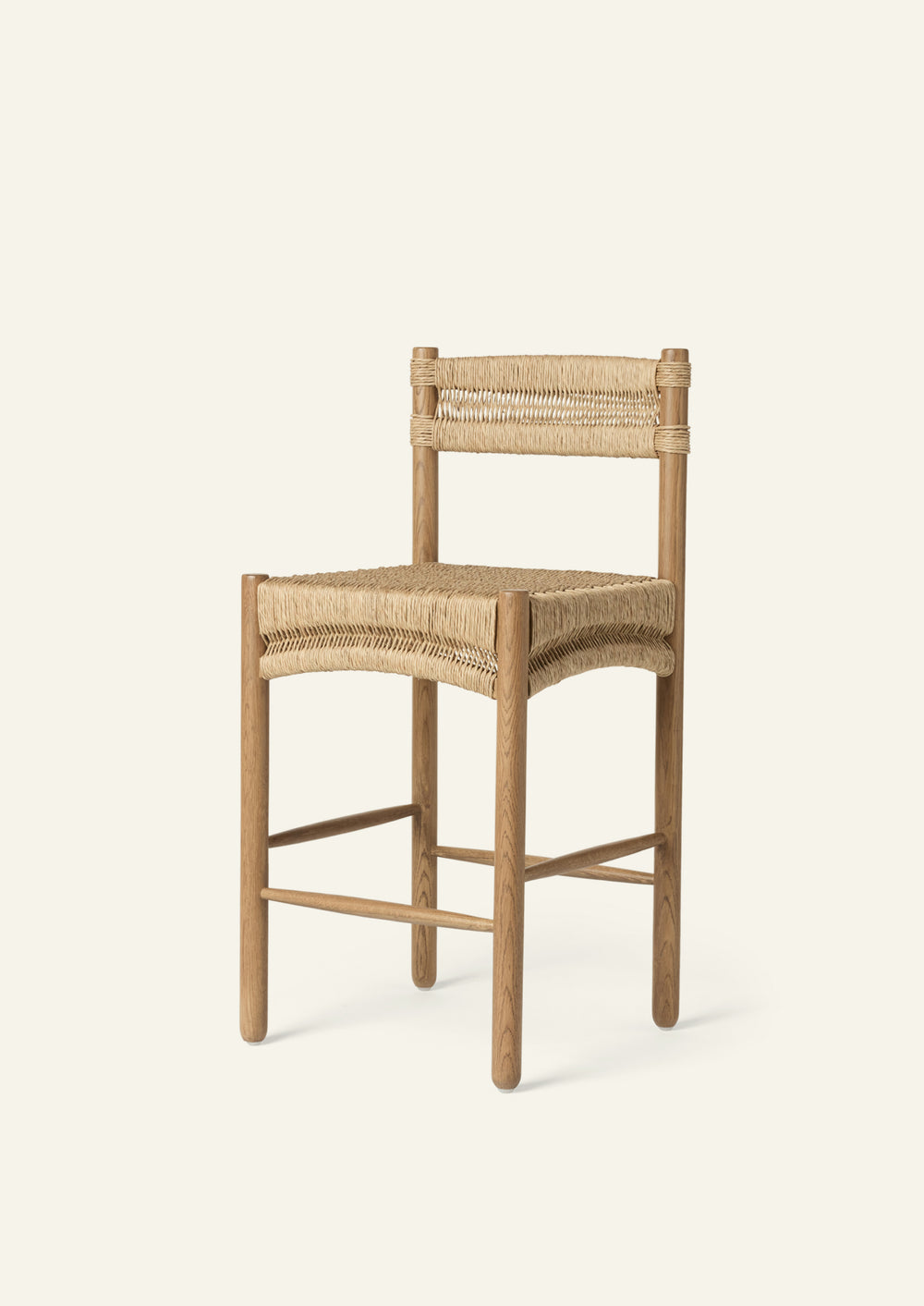 Three-quarter view of a counter stool crafted from solid honey oak and handwoven natural rush. The sculpted woven seat and wrapped backrest create a warm, textural silhouette suited for kitchen islands and casual gathering spaces.