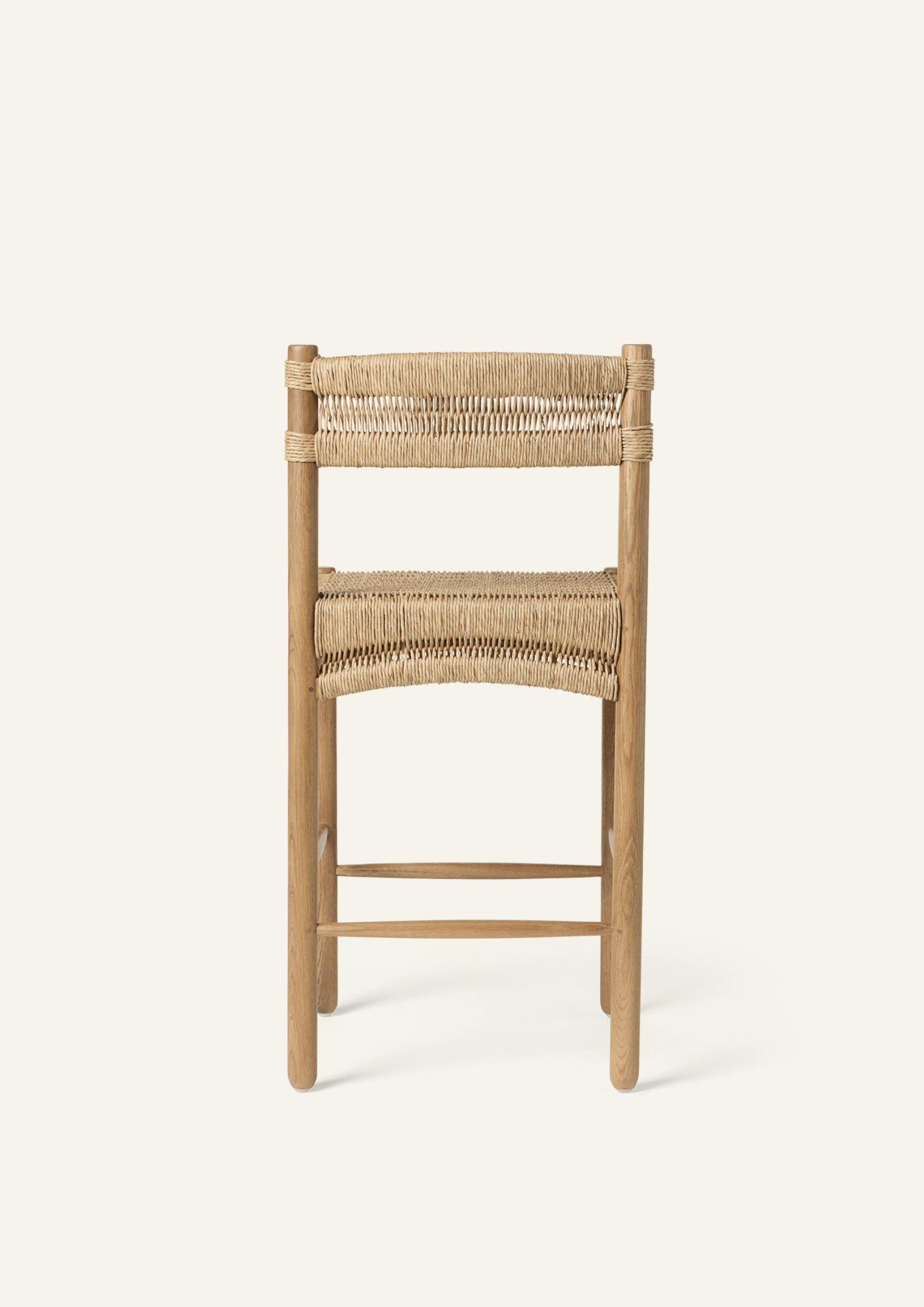 Rear view of the counter stool showcasing a woven rush backrest secured around solid oak posts. Clean lines and natural materials give the design a timeless, coastal-inspired character.