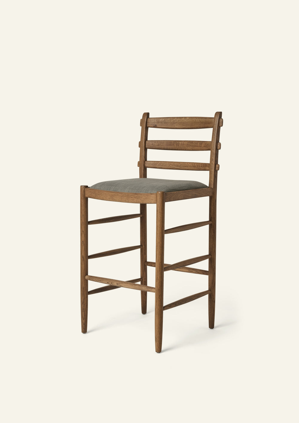 Tiga Counter Stool with a solid honey oak frame an upholstered performance slate linen seat, shown from an angled front view on a neutral background.