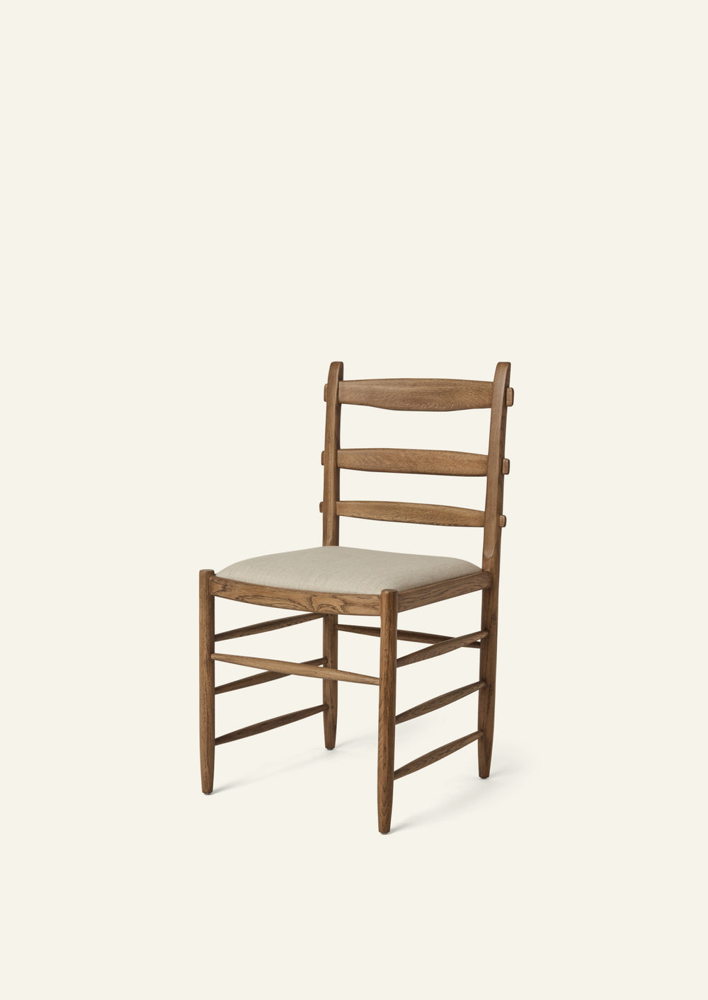 Tiga Dining Chair in honey oak with an upholstered performance sand linen seat, shown from an angled front view on a neutral background.