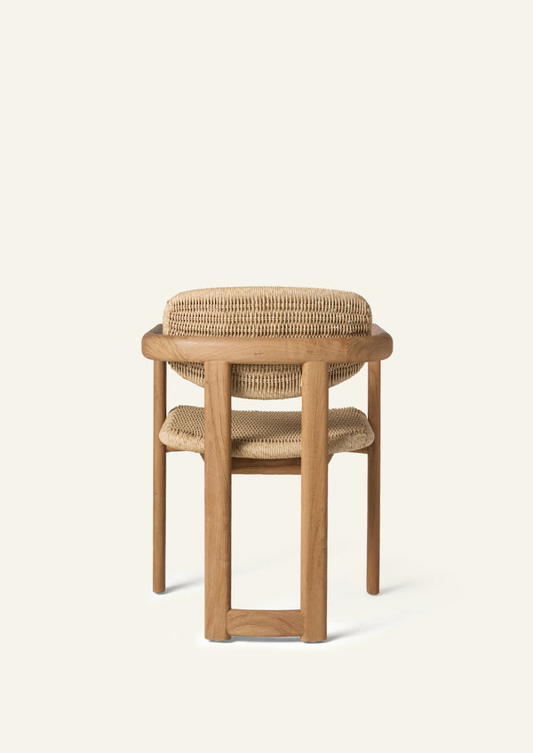 Rear view of the dining armchair highlighting its curved woven backrest, solid teak frame, and supportive construction. The open design balances visual lightness with durability.