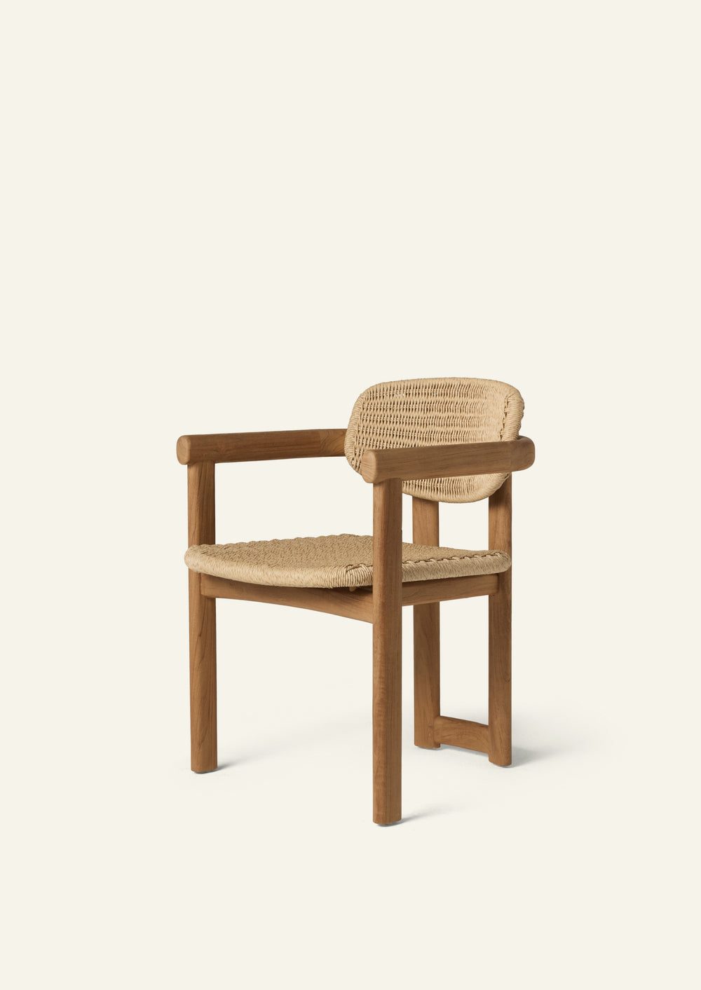 Three-quarter view of an outdoor dining armchair crafted from solid teak and woven synthetic paper cord. Rounded arms, a woven seat, and a curved woven backrest create a comfortable silhouette designed for both indoor and outdoor living.