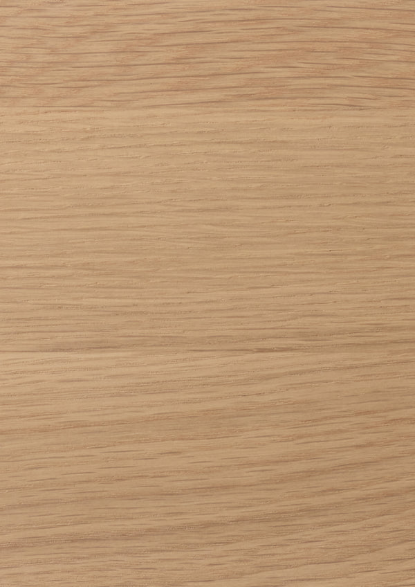Close-up of a light oak surface with a light tan color and visible grain pattern.
