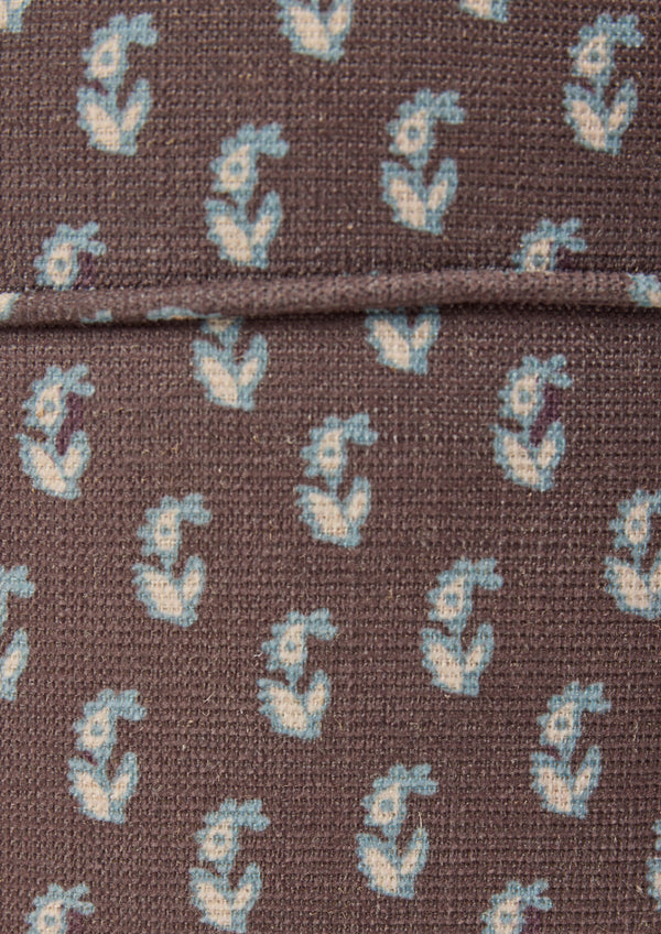 Close-up of the Cocoa Floral fabric by Cleobella. A cool brown base with individual paisleys in ivory with a blue outline.