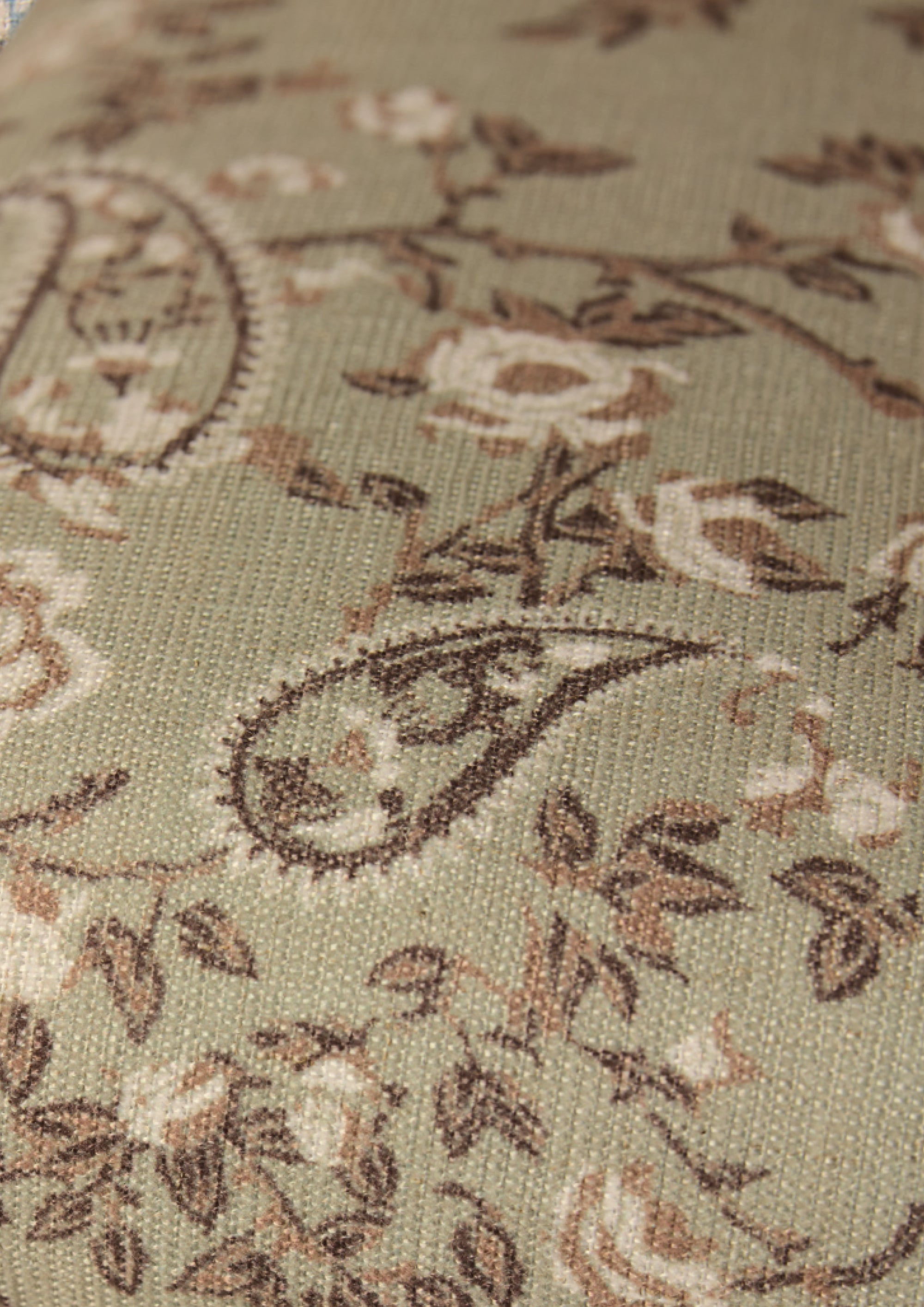 Ivory, tan and brown paisley fabric on a muted green base. 