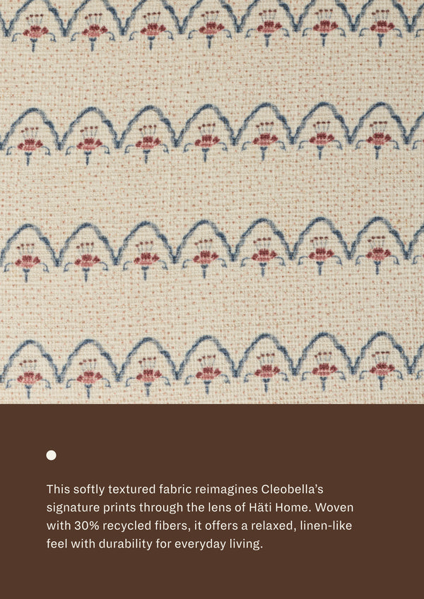 Close-up of the Neutral Arches fabric, featuring repeating blue scalloped lines and dusty rose floral-inspired motifs on a soft cream woven ground. The textured textile offers a relaxed, linen-like appearance with subtle dimension.
