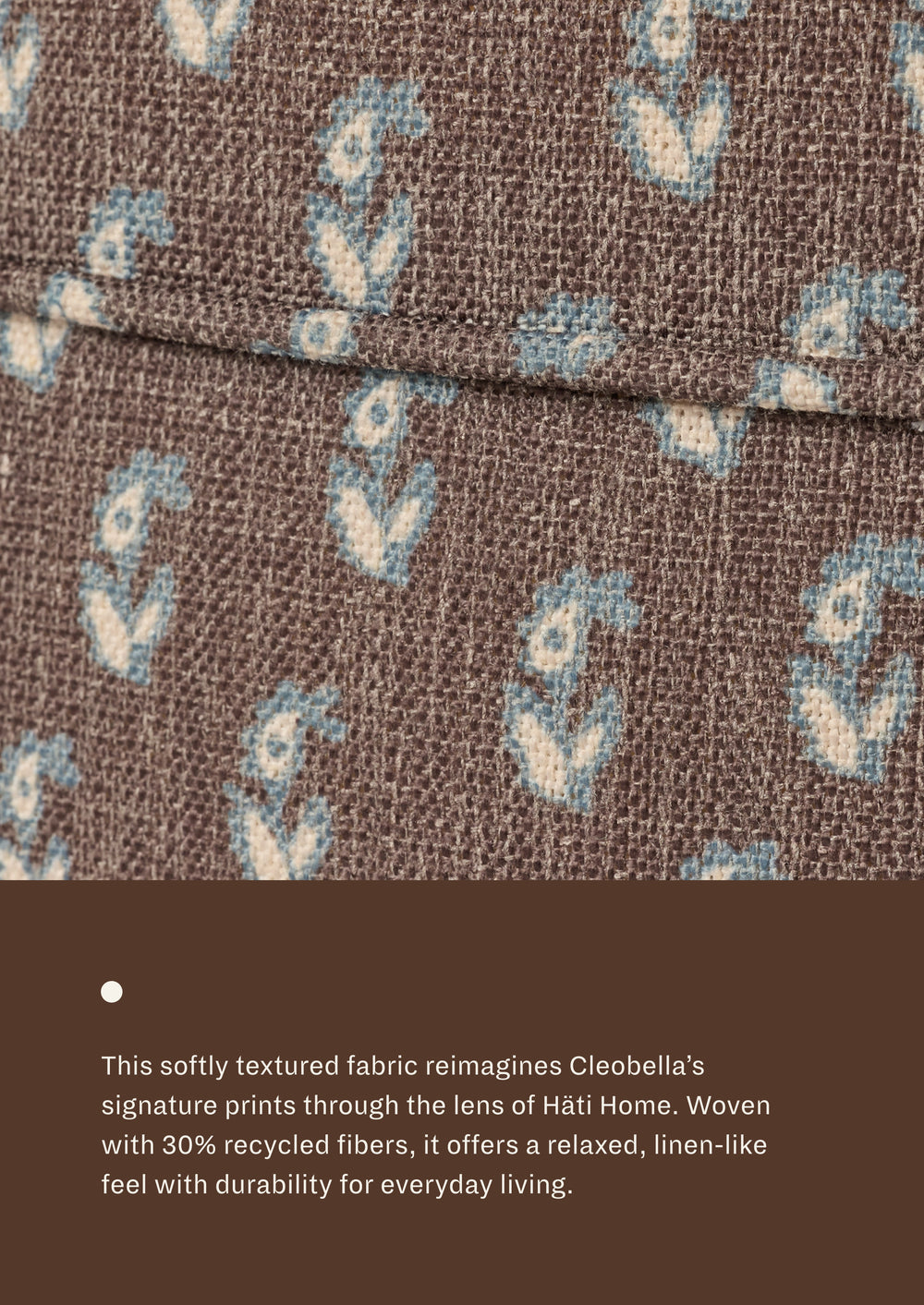 Close-up of the Cocoa Floral fabric, featuring small blue and cream floral motifs scattered across a deep brown woven ground. Woven with recycled fibers, the textile offers a relaxed, linen-like texture designed for everyday durability and comfort.
