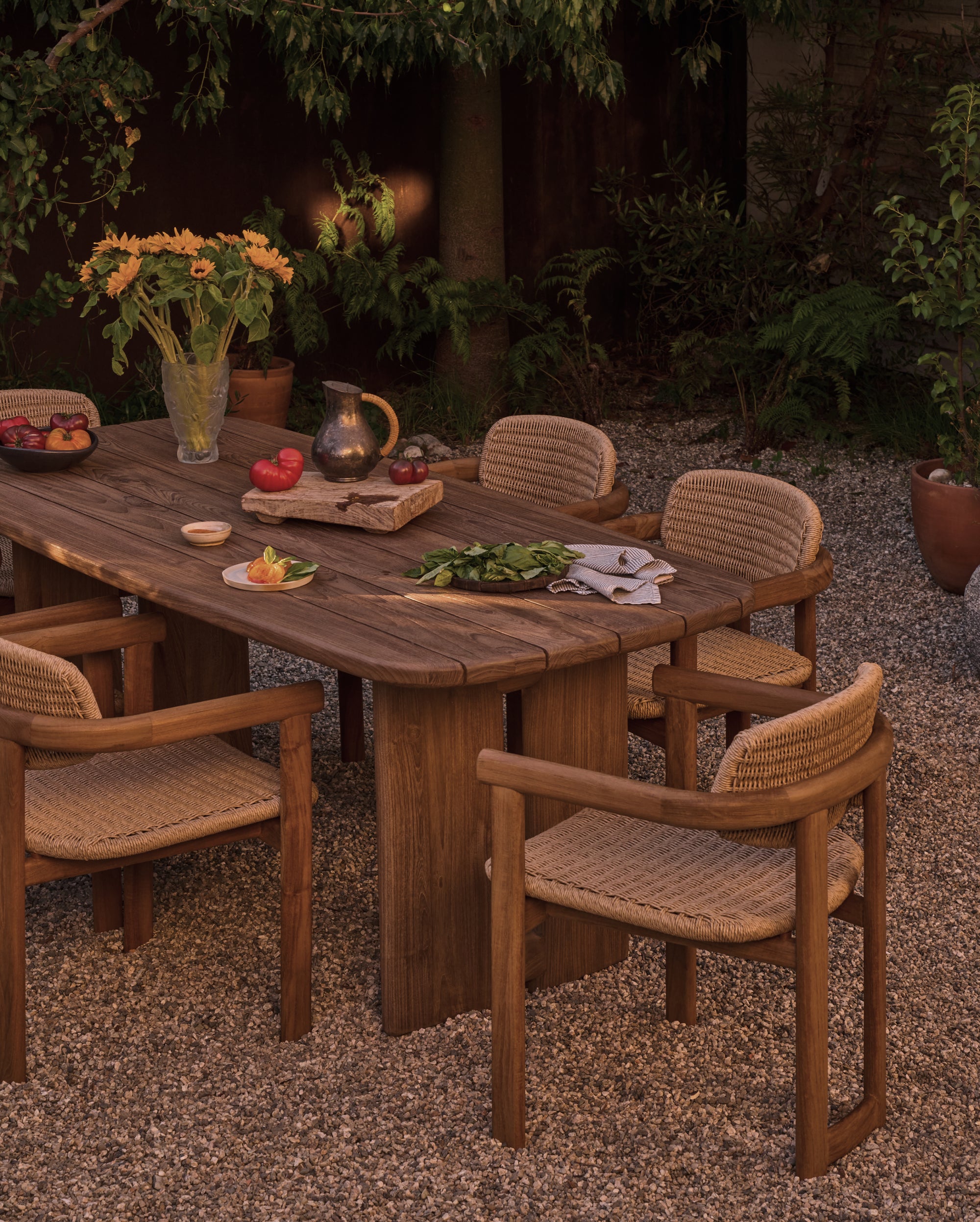 Hollis Dining Table with chairs in a garden setting