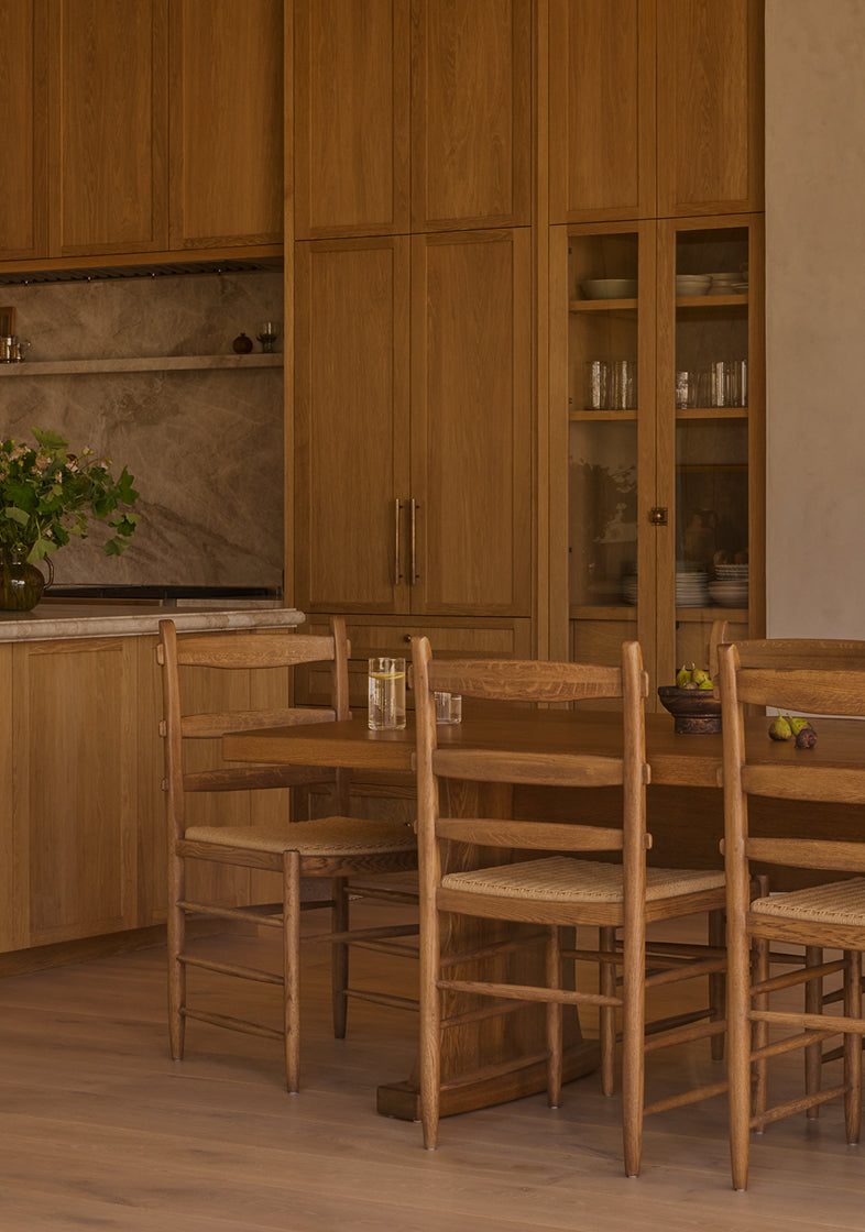 Wooden dining set with table and chairs in a kitchen.