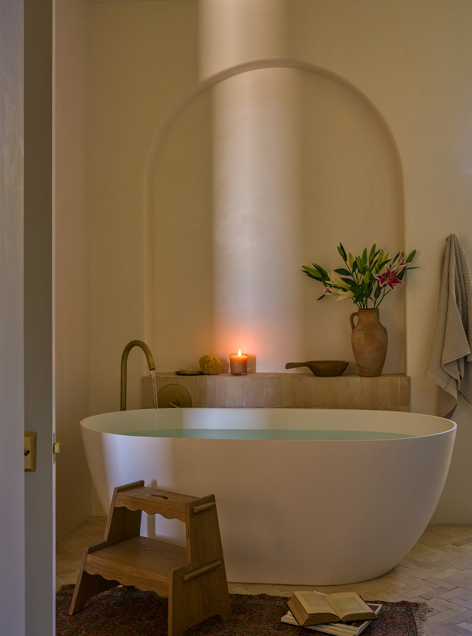 Bathroom with a freestanding bathtub, the margot step stool, and decorative items.