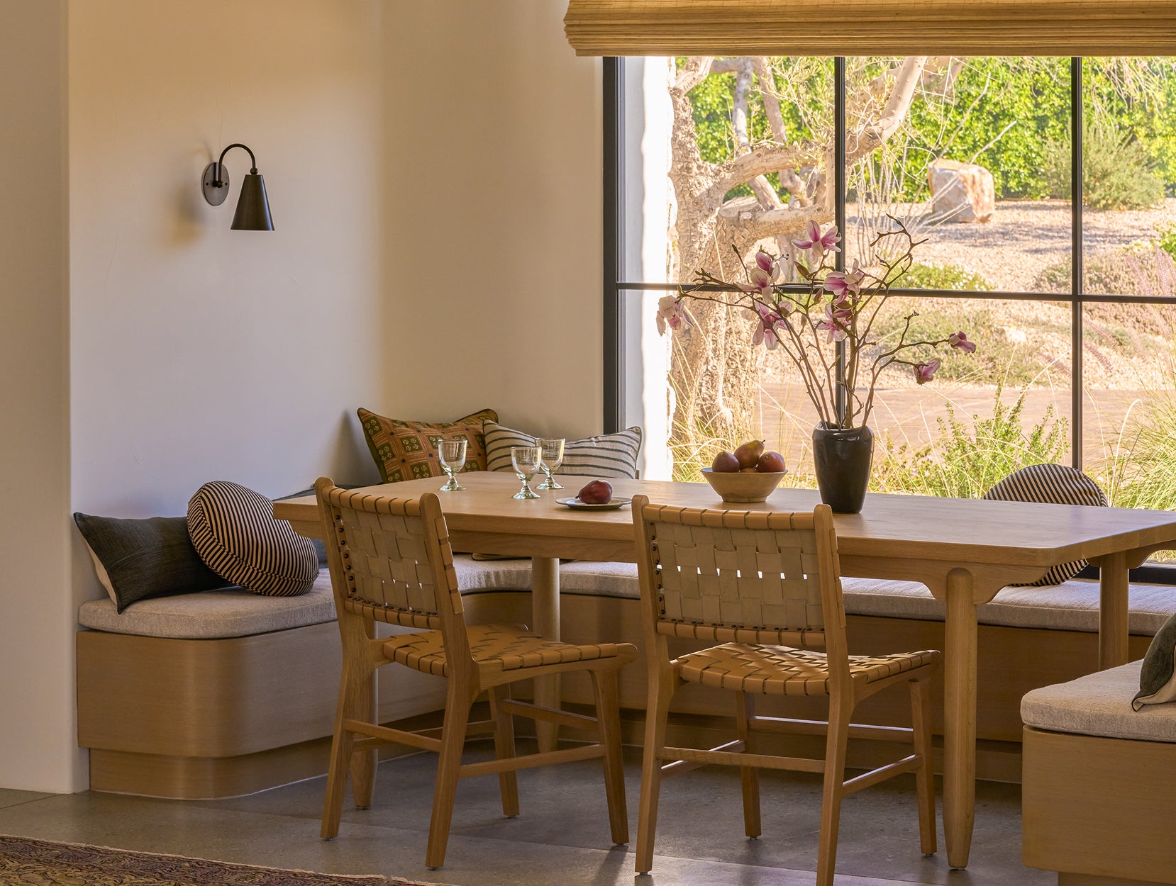Dining area with Anders table and Bali dining chairs, cushioned bench, and large window view.