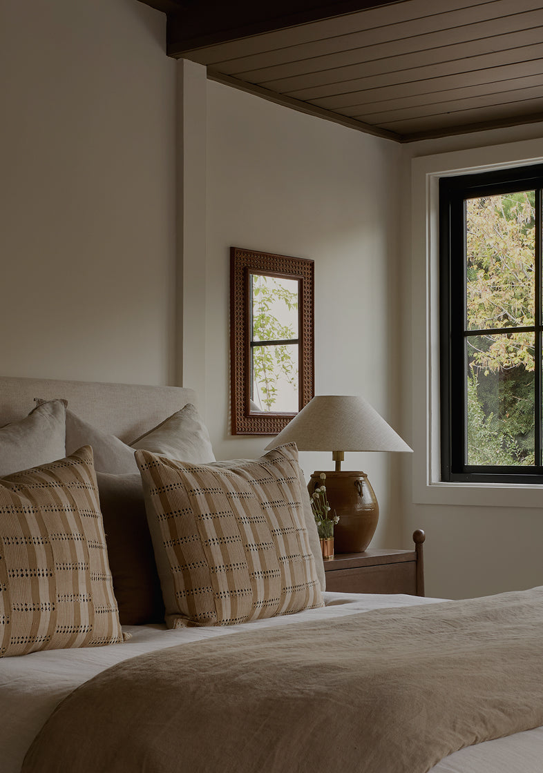 Bedroom with a bed, lamp, and window view