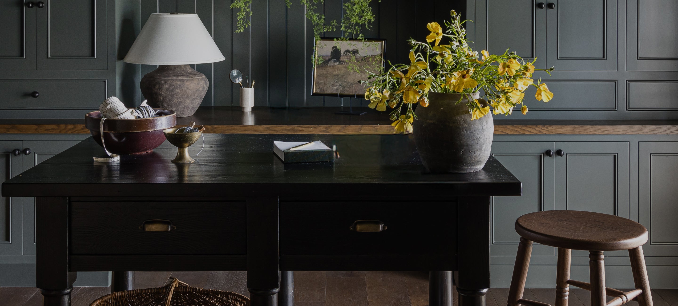 Lea counter stool with a vase of yellow flowers in a kitchen setting.
