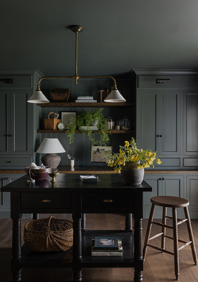 Lea counter stool with a vase of yellow flowers in a kitchen setting.