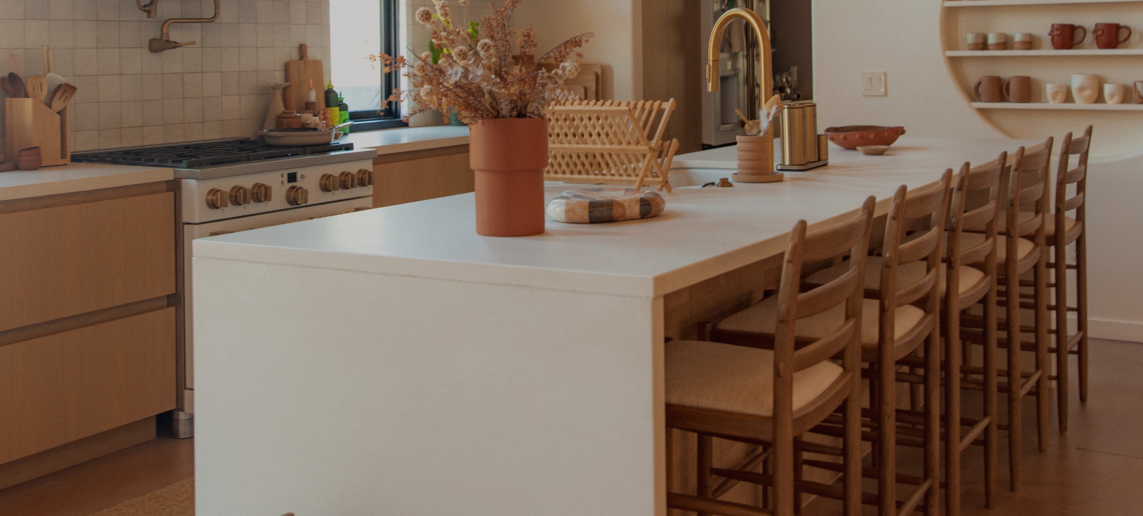 Modern kitchen with a white island and tiga counter stools.